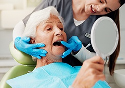 A woman being treated by a dentist.