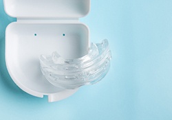Clear nightguard in white carrier case with pale blue background