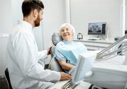 a patient smiling about dentures in Green Hills