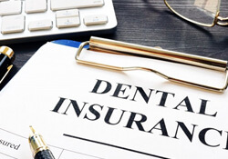 a dental insurance form next to a keyboard