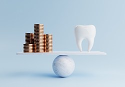 Tooth on a scale with a pile of coins