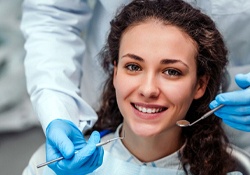 young woman smiling in dental chair 