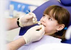 Young girl receiving fluoride treatment