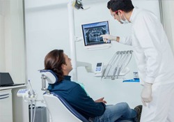 Dentist and patient looking at dental x-rays