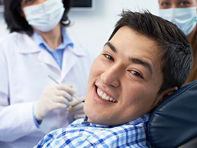 young man smiling with dental implants in Green Hills