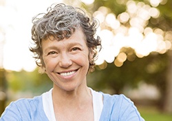 woman smiling after getting dentures in Green Hills 