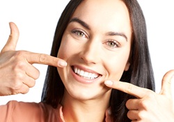 Women in pink smiling at dentist