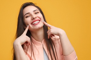 woman pointing to her teeth