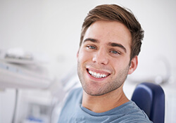 man in blue shirt smiling