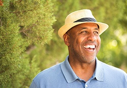 man smiling in a forest 