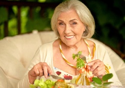 An older woman eating a salad for lunch in Green Hills