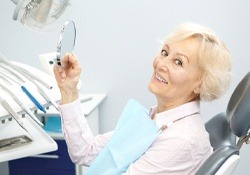 older woman smiling in dental chair 