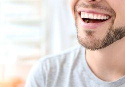 close up of a man smiling 