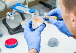 a lab technician crafting dentures