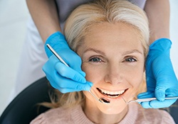 Older woman undergoing a teeth cleaning