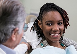 Patient smiling while talking to dentist