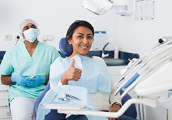 Woman giving thumbs up after nitrous oxide sedation in Nashville