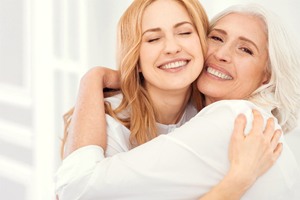 A young woman and an older woman hugging