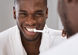 Man brushing teeth to avoid a toothache in Nashville