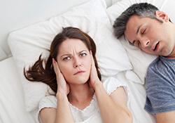 Women holding ears to block noise