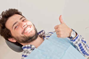 man in dentist chair smiling