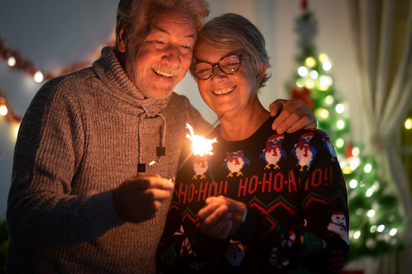 older couple looking at flame at holiday time