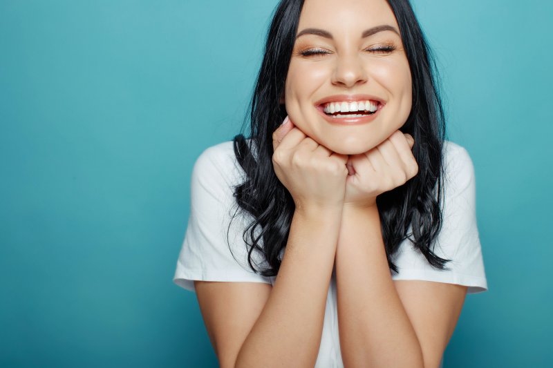 woman smiling with porcelain veneers at Green Hills