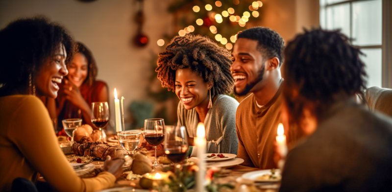 A family enjoying a Thanksgiving feast while taking care of their oral health