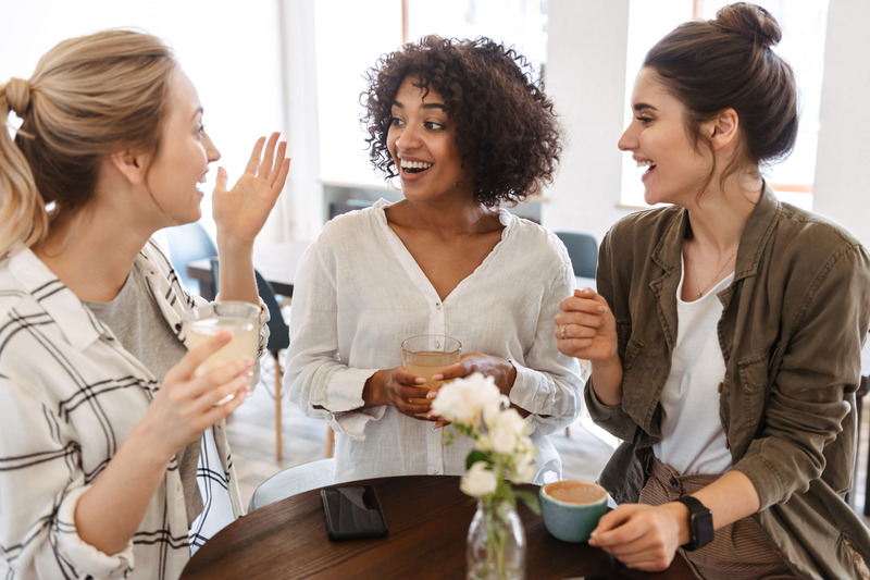Patient with veneers enjoying coffee with friends
