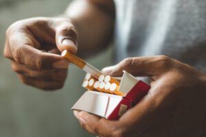 Person getting a cigarette from a pack