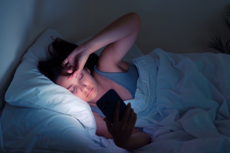person on their cell phone at night